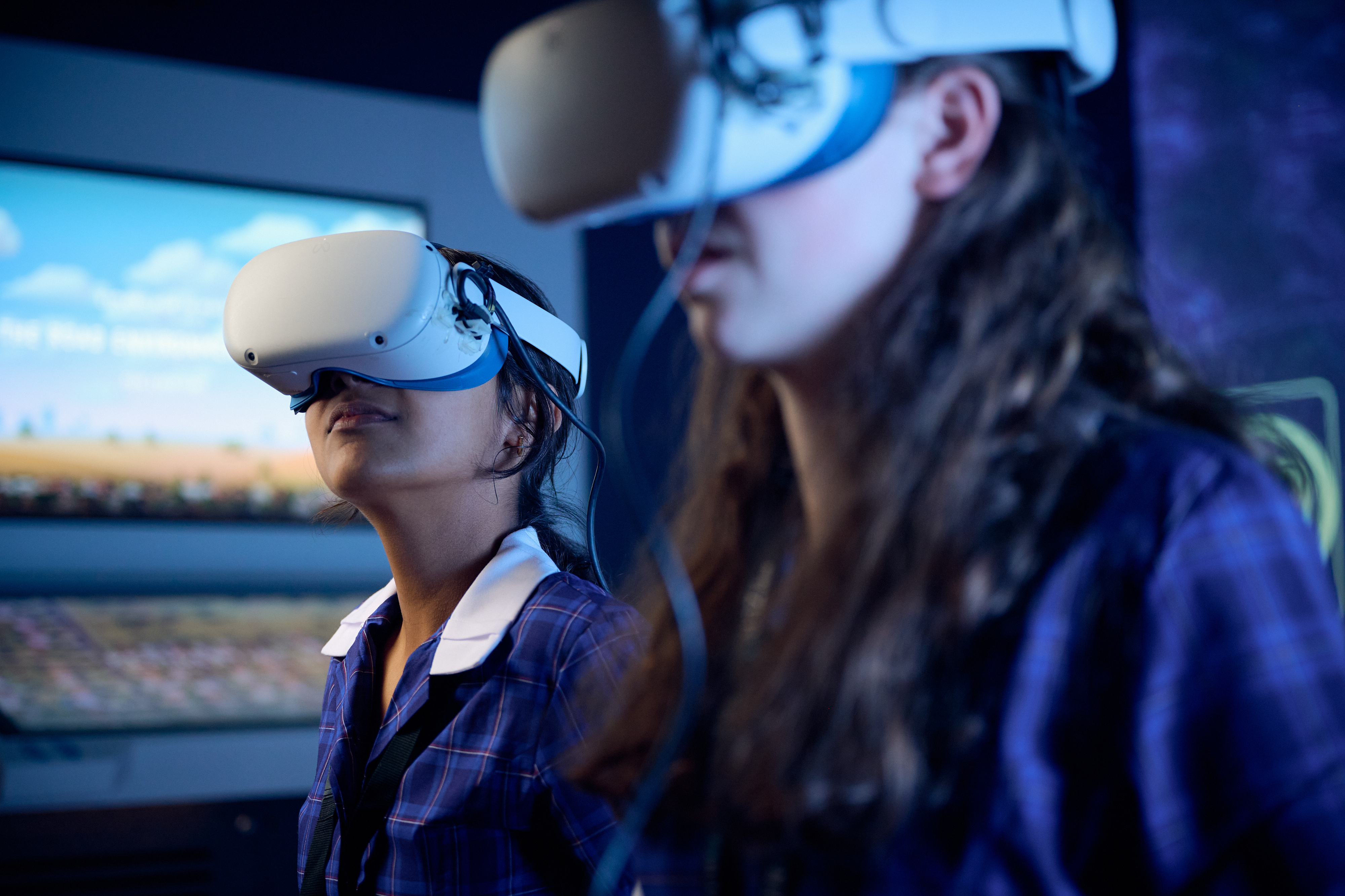 Two female students wearing virtual reality headsets